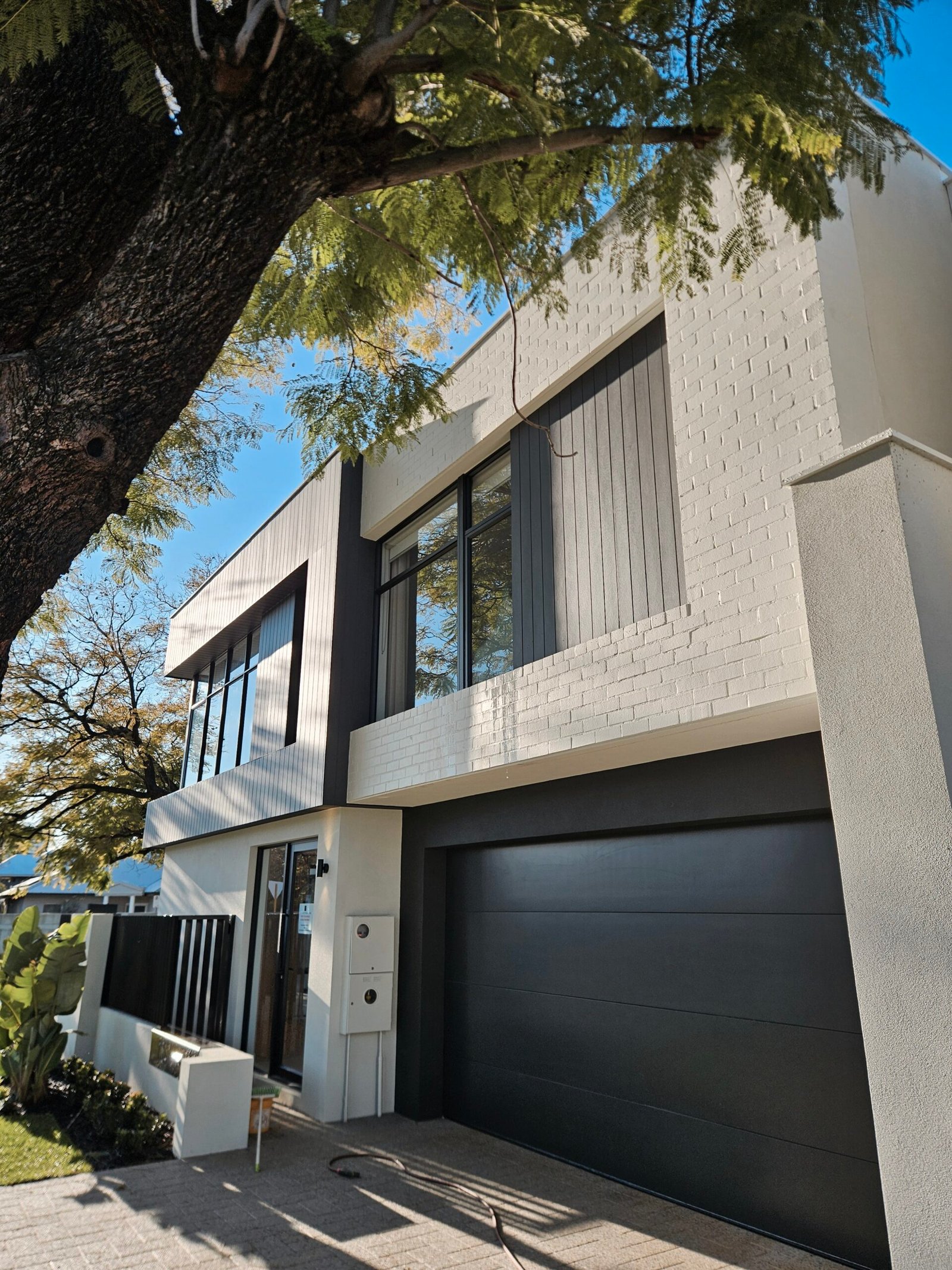 External brick paint applied to a textured brick wall